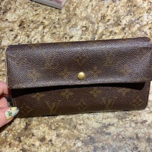 GENUINE LOUIS VUITTON wallet. Three areas inside, including logo zippered area.